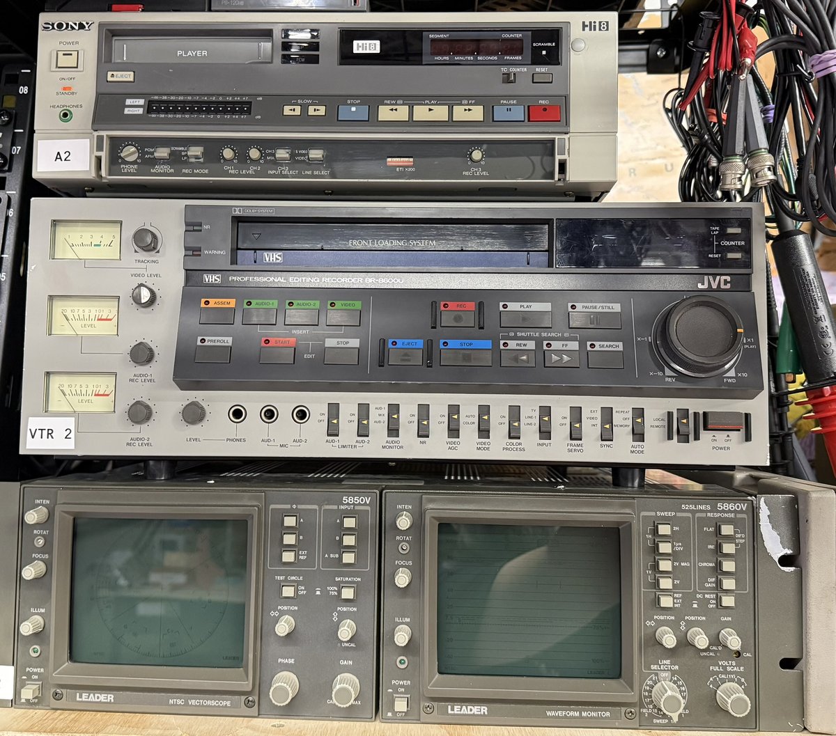 Professional VHS archiving equipment — JVC editing recorder, Sony Hi8, Leader waveform monitor and vectorscope